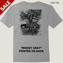 Load image into Gallery viewer, old ford surf woody and surfboard against tree roots